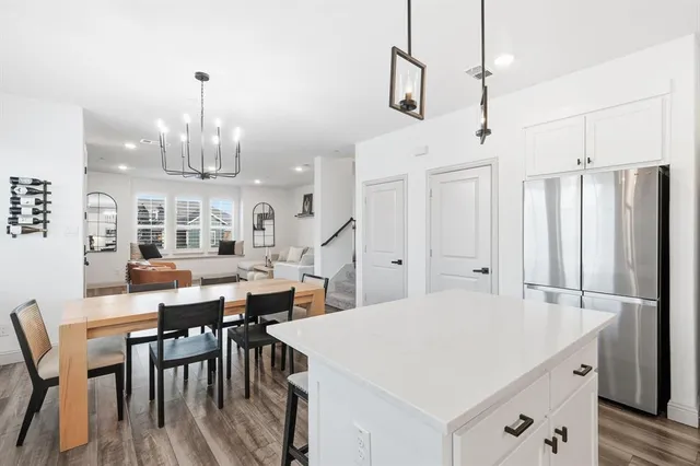 a large kitchen with a table and chairs