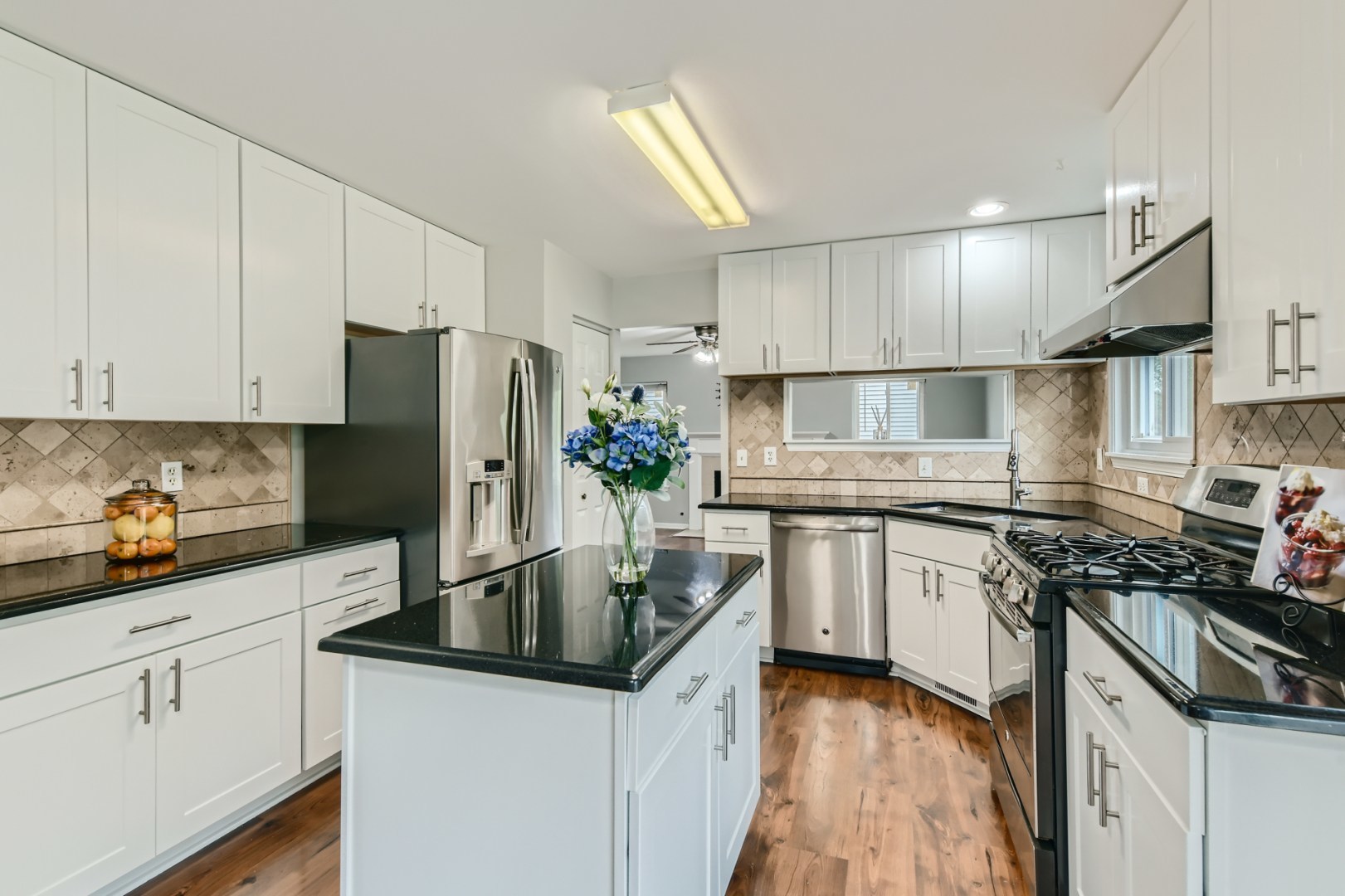 512 Susan Street Romeoville, IL 60446 - Photo 3 of 21 a kitchen with granite countertop a sink a counter space stainless steel appliances and cabinets
