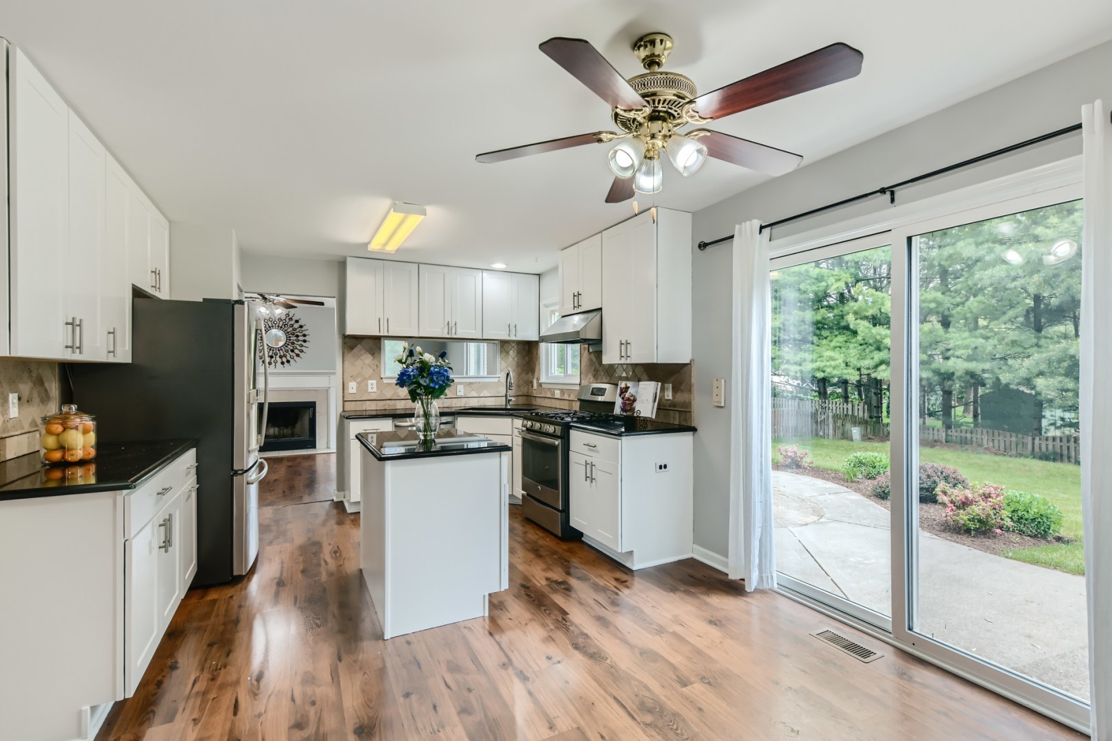 512 Susan Street Romeoville, IL 60446 - Photo 5 of 21 a kitchen with refrigerator cabinets and wooden floor