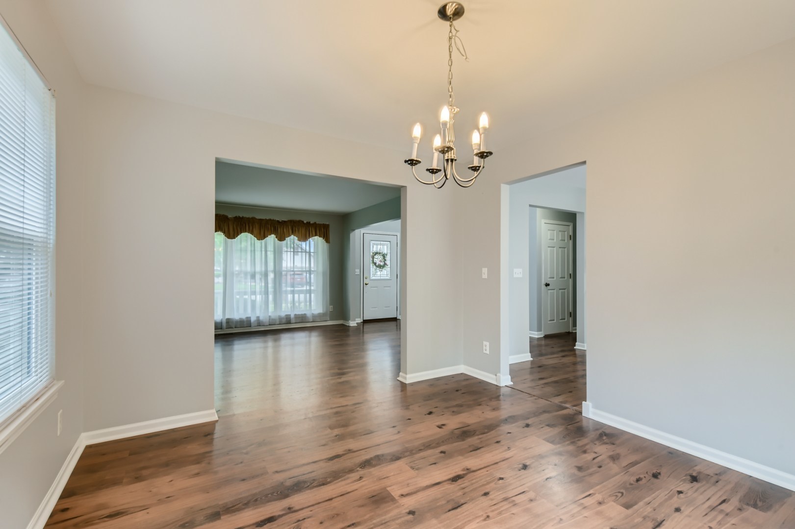 512 Susan Street Romeoville, IL 60446 - Photo 7 of 21 a view of empty room with wooden floor and chandelier