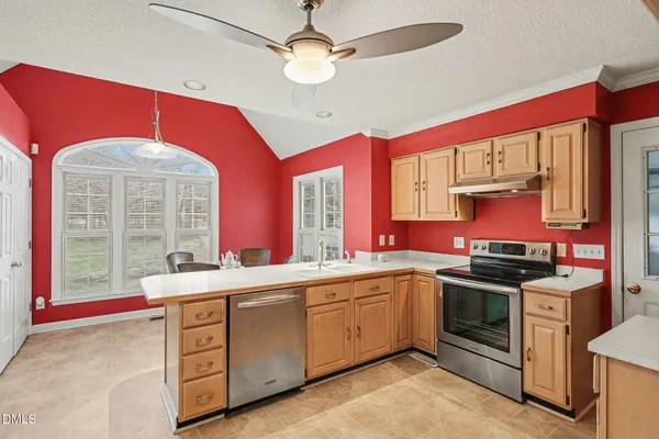 a kitchen with a sink stove and cabinets