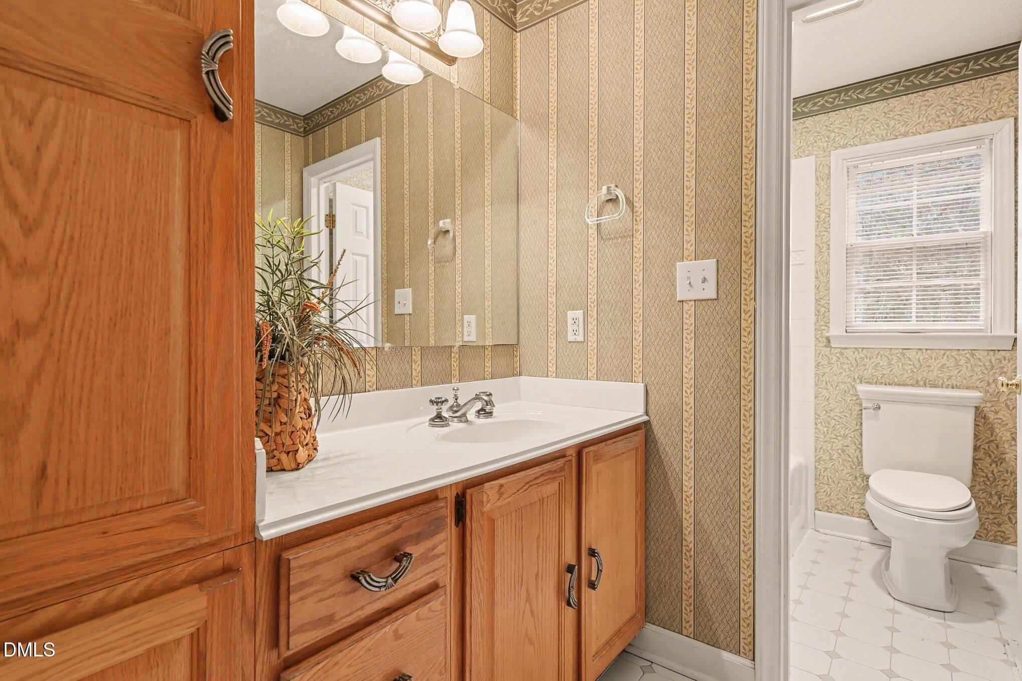 1121 Milton Road Durham, NC 27712 - Photo 14 of 31 a bathroom with a sink and a mirror