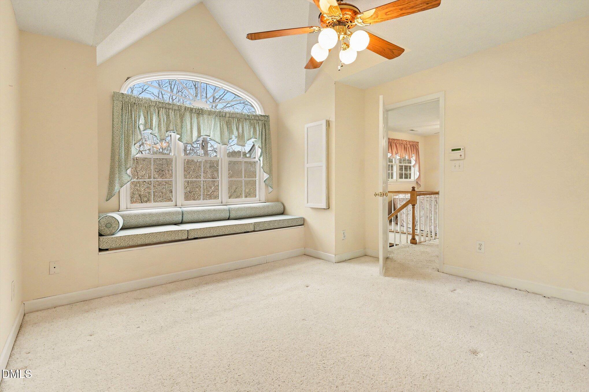 1121 Milton Road Durham, NC 27712 - Photo 19 of 31 an empty room with windows and chandelier fan