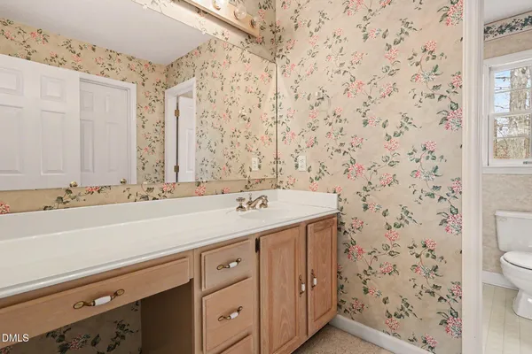 a bathroom with a sink a toilet and a shower curtain
