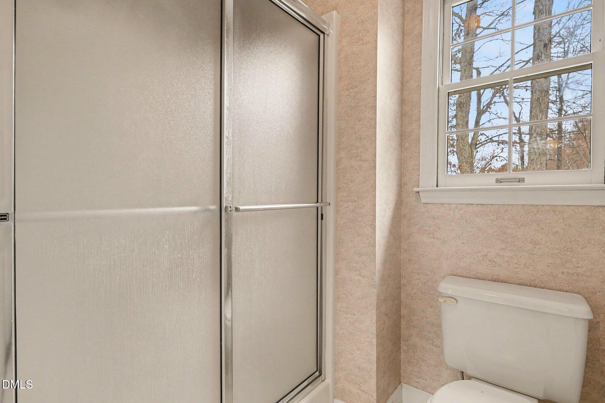 1121 Milton Road Durham, NC 27712 - Photo 21 of 31 a bathroom with a toilet and a shower