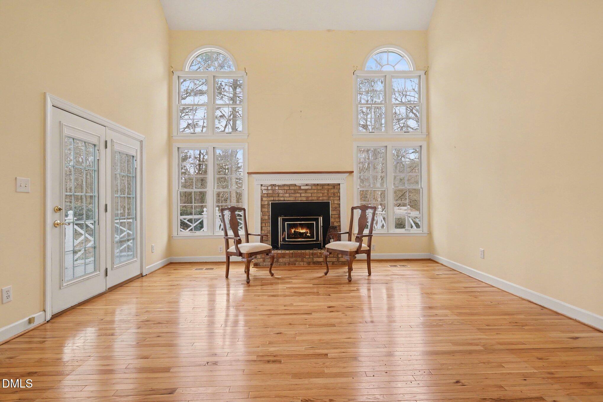 1121 Milton Road Durham, NC 27712 - Photo 4 of 31 a view of a livingroom with furniture wooden floor windows and a fireplace