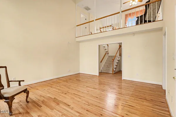 a view of a livingroom with wooden floor and a staircase