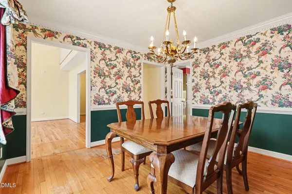 a view of a dining room with furniture and chandelier