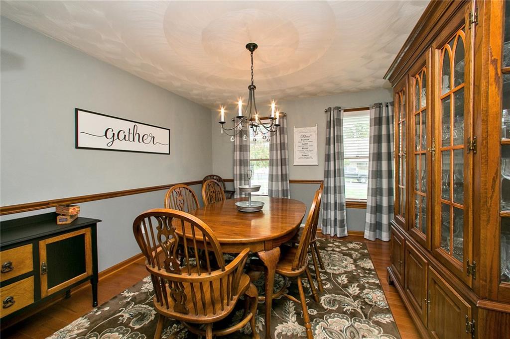 83 Rustic Ridge Drive Pittsburgh, PA 15239 - Photo 6 of 25 Gather in the Dining Room that Features Oak Hard Wood Flooring and Chair Rail