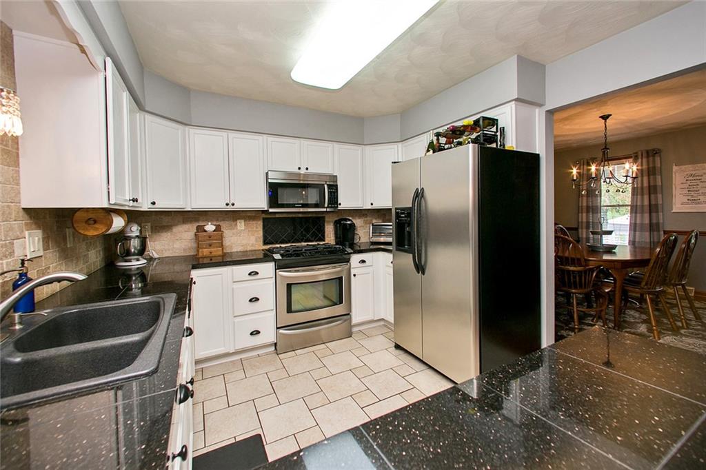 83 Rustic Ridge Drive Pittsburgh, PA 15239 - Photo 10 of 25 The Kitchen has Stainless Steel Appliances, Tumbled Marble Back Splash, Black Galaxy Granite Counter Tops, a Composite Granite Double Bowl Sink, Lots of Cabinet Space