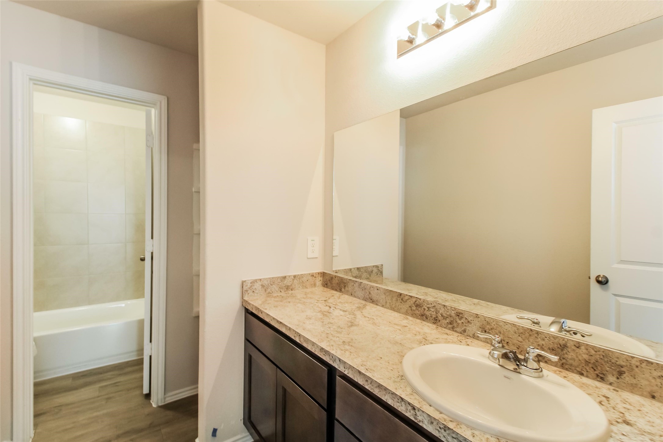 2529 Grayling Drive Conroe, TX 77384 - Photo 11 of 18 a bathroom with a granite countertop sink and a mirror