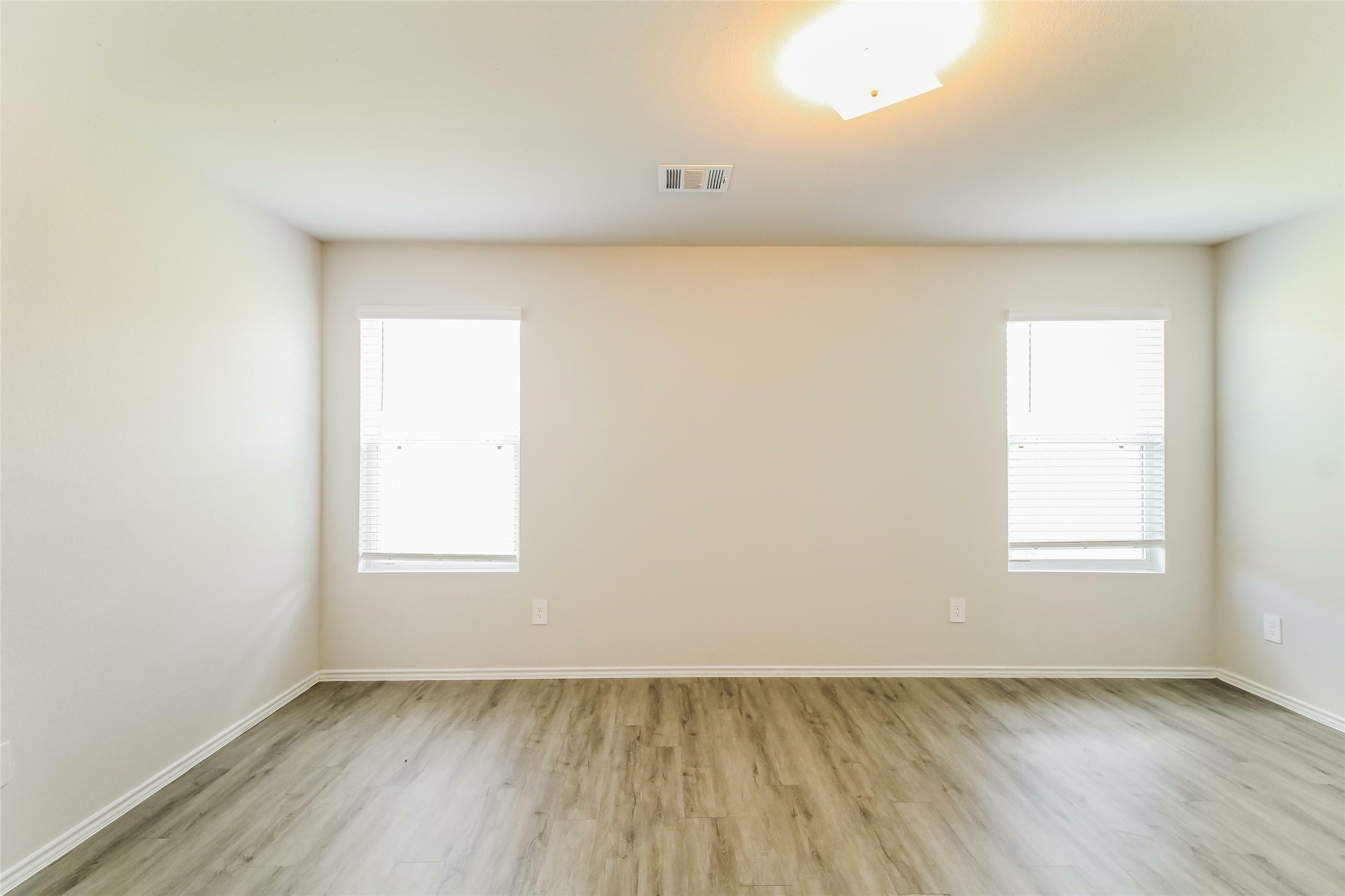 2529 Grayling Drive Conroe, TX 77384 - Photo 10 of 18 an empty room with wooden floor and windows