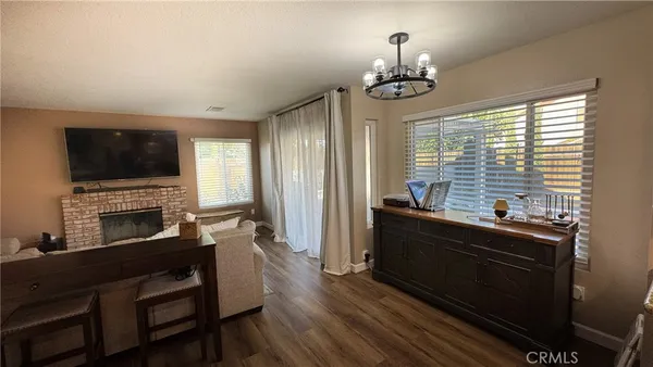 a living room with furniture fireplace and flat screen tv