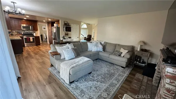 a living room with furniture and view of kitchen