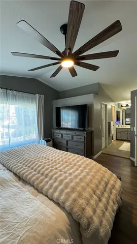 a large bedroom with a bed and a chandelier
