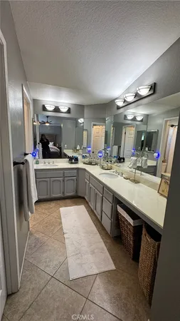a large kitchen with a large counter top space a sink stainless steel appliances and cabinets