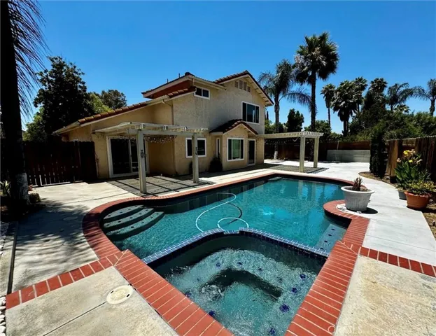 a front view of a house with swimming pool having outdoor seating
