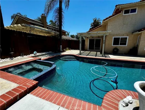 a view of a house with pool and chairs