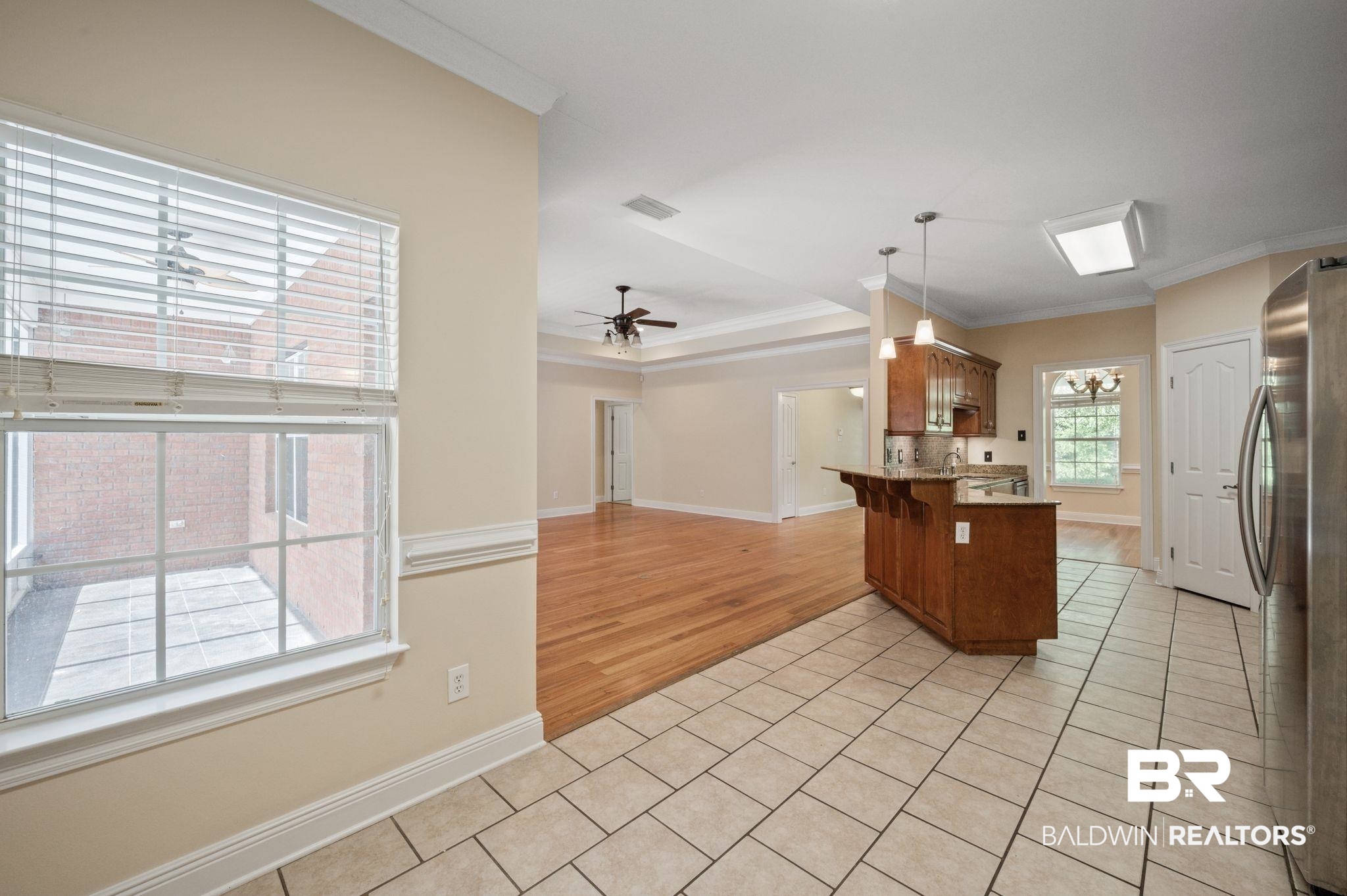 2041 Ridgeline Drive Mobile, AL 36695 - Photo 11 of 43 Kitchen with light tile patterned flooring, ceiling fan, pendant lighting, ornamental molding, and stainless steel fridge