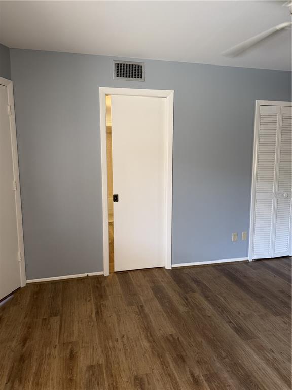 2004 Longpointe Circle Venice, FL 34293 - Photo 33 of 54 an empty room with wooden floor and cabinet