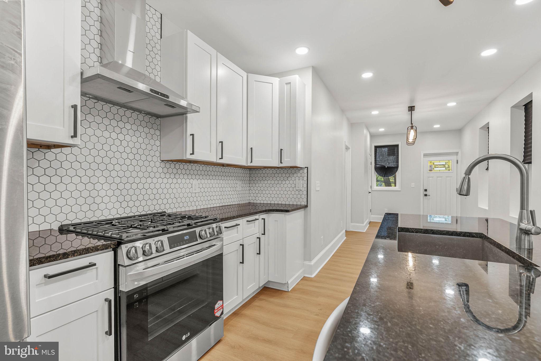 5737 Springfield Avenue Philadelphia, PA 19143 - Photo 11 of 31 a kitchen with granite countertop a stove and a sink