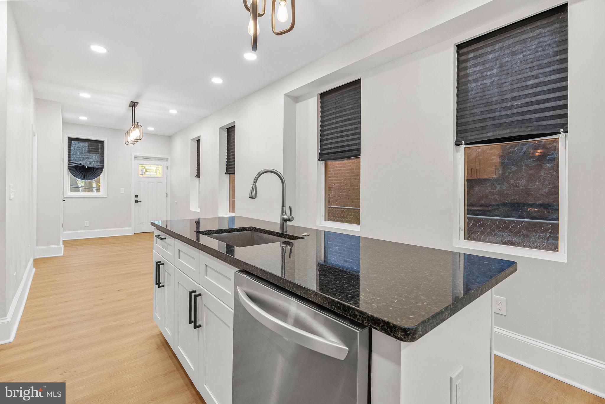 5737 Springfield Avenue Philadelphia, PA 19143 - Photo 12 of 31 a kitchen with granite countertop a sink and a stove