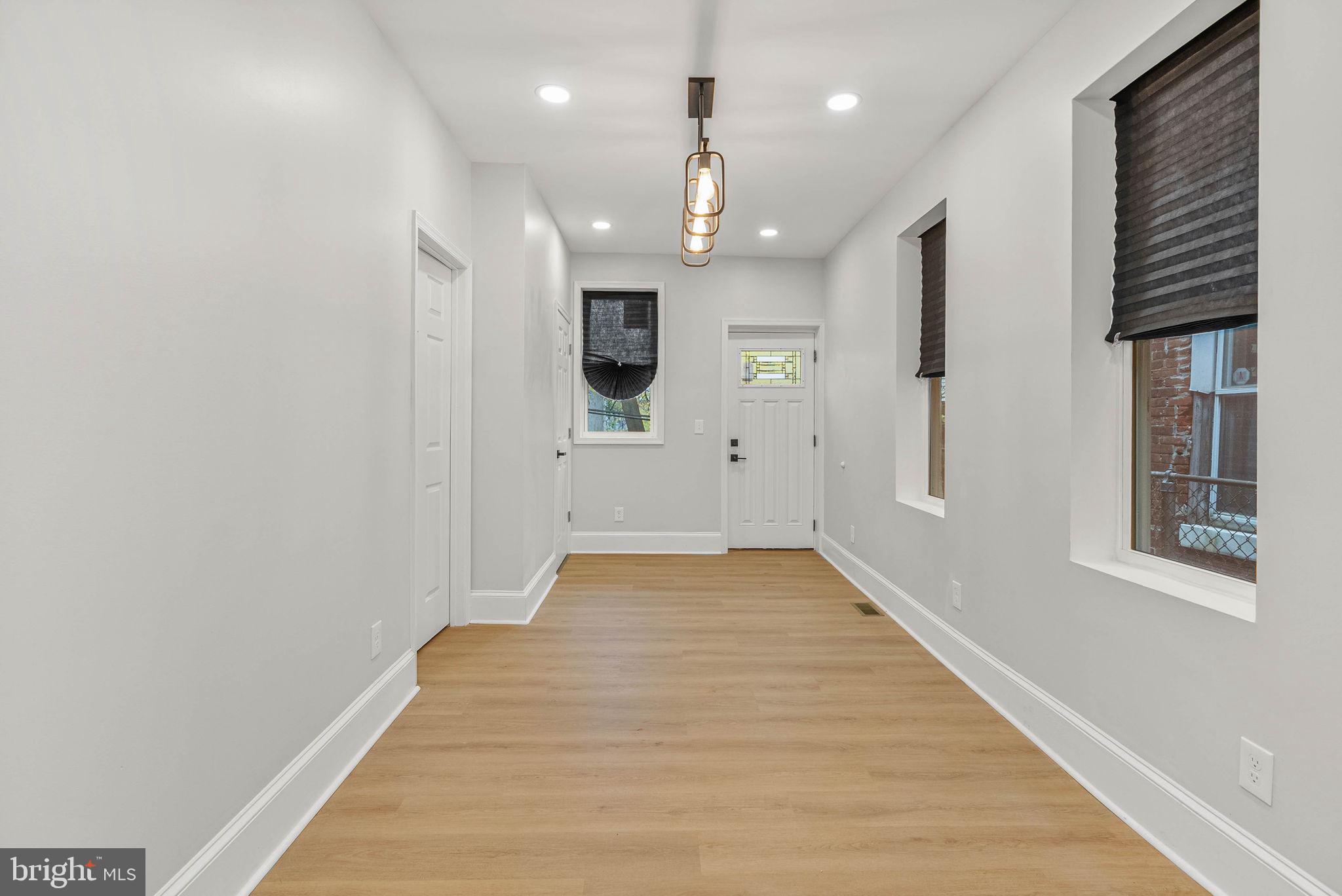 5737 Springfield Avenue Philadelphia, PA 19143 - Photo 15 of 31 a view of a hallway with wooden floor and a large window