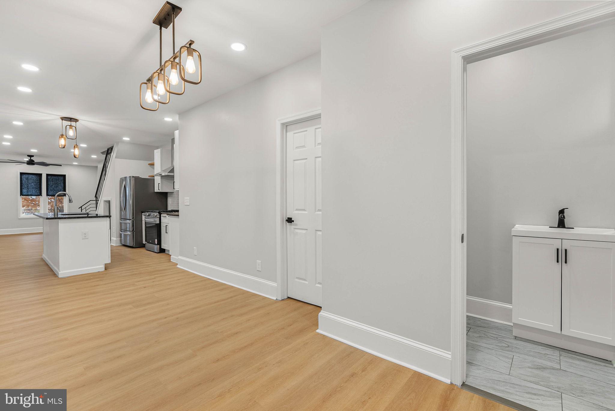 5737 Springfield Avenue Philadelphia, PA 19143 - Photo 17 of 31 a view of a kitchen with cabinets and wooden floor