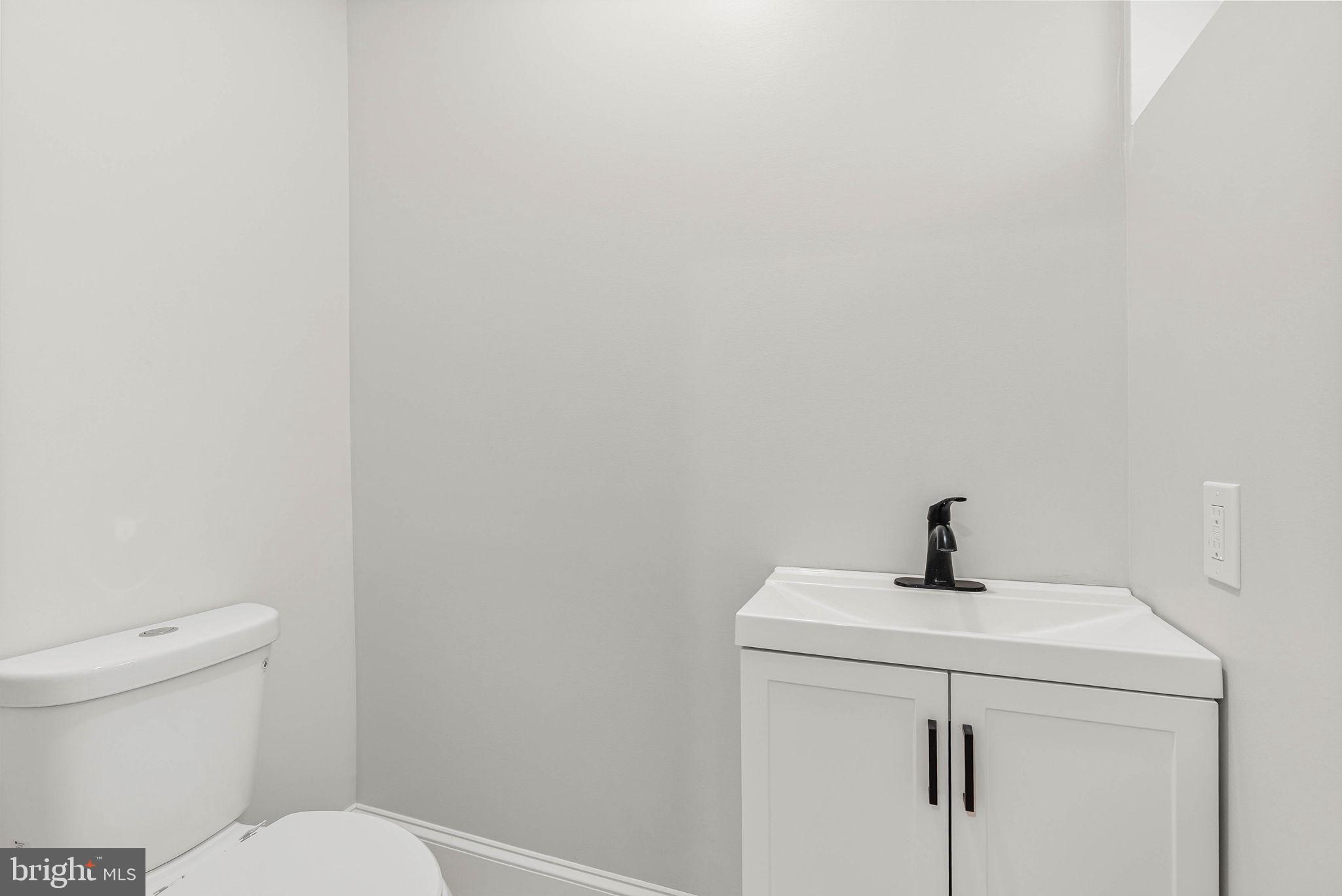 5737 Springfield Avenue Philadelphia, PA 19143 - Photo 18 of 31 a bathroom with a sink a toilet and a mirror