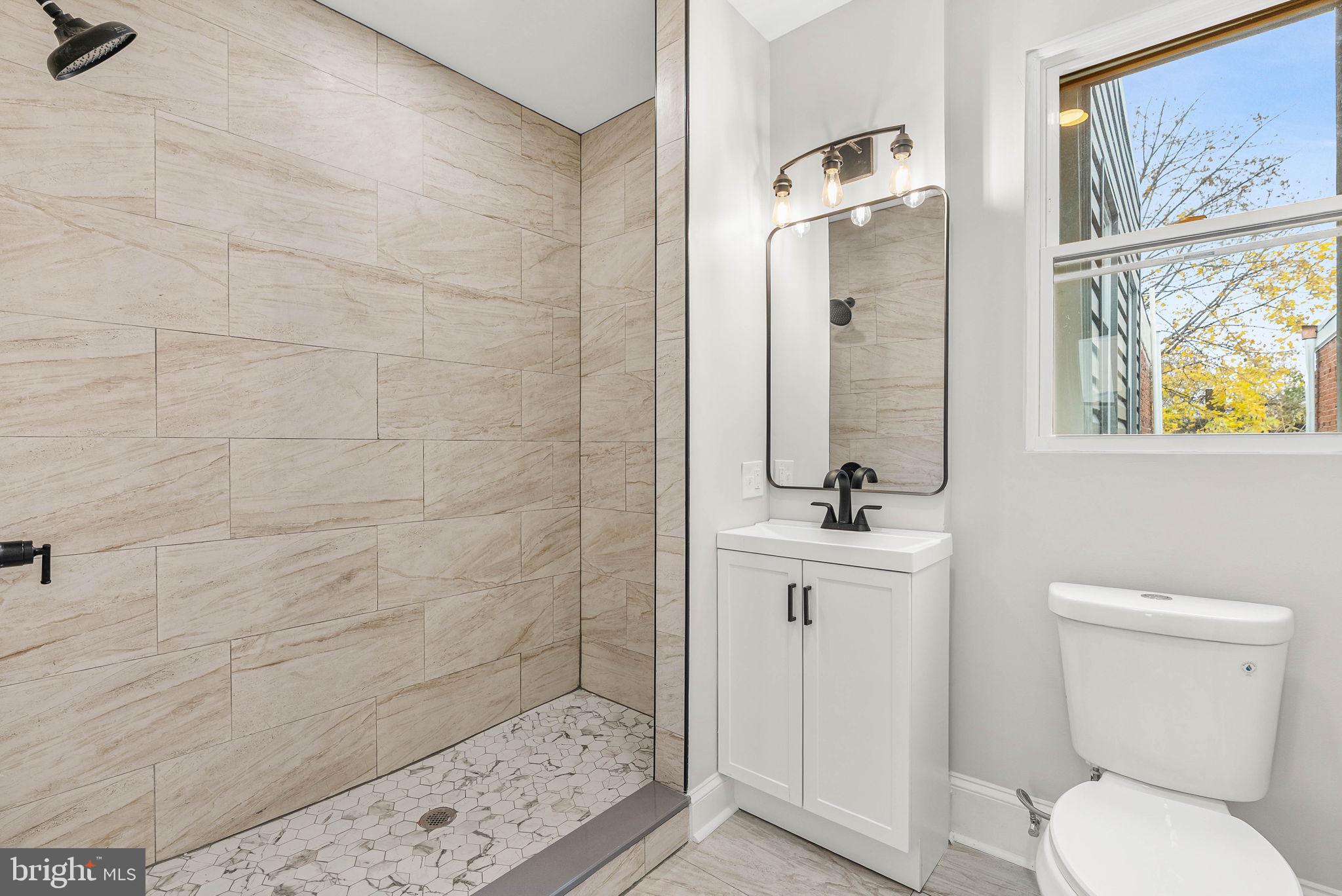 5737 Springfield Avenue Philadelphia, PA 19143 - Photo 23 of 31 a bathroom with a sink a toilet and shower