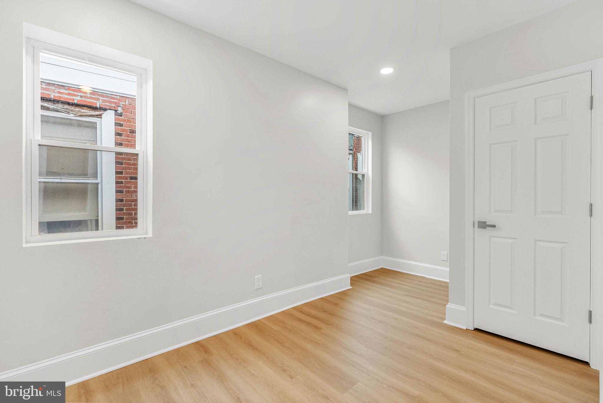 5737 Springfield Avenue Philadelphia, PA 19143 - Photo 24 of 31 a view of an empty room with wooden floor and a window