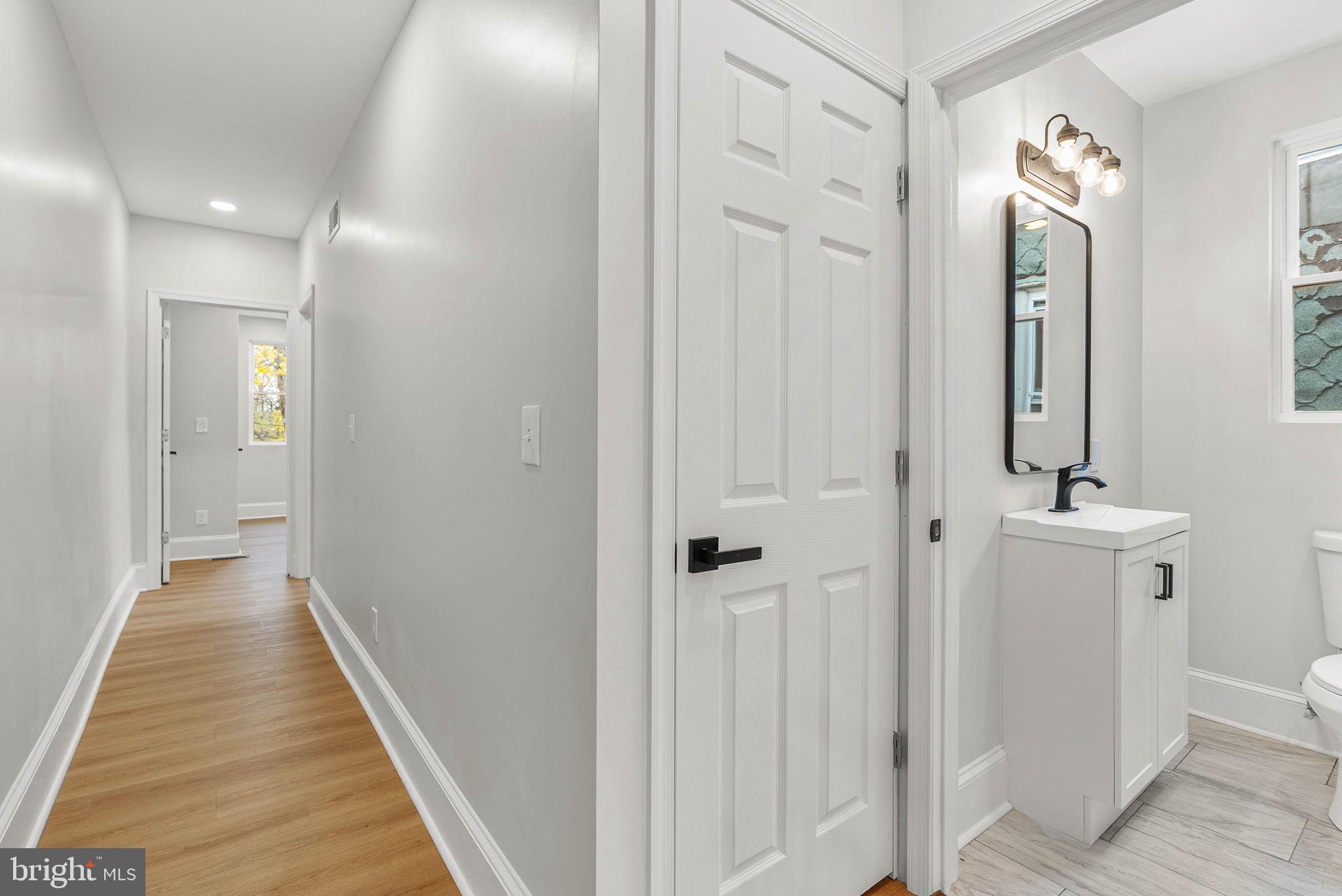 5737 Springfield Avenue Philadelphia, PA 19143 - Photo 27 of 31 a view of a hallway with a door and chandelier