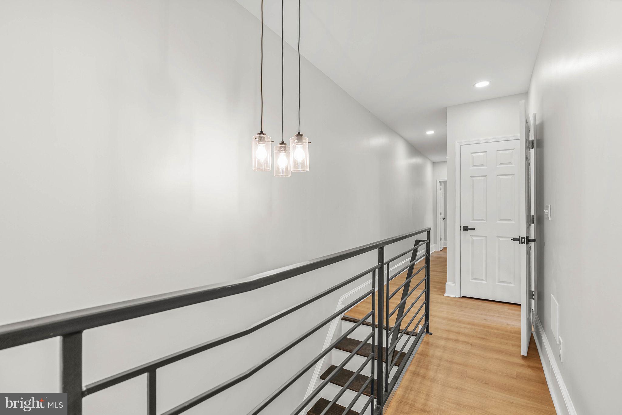 5737 Springfield Avenue Philadelphia, PA 19143 - Photo 29 of 31 a view of a hallway with wooden floor and staircase
