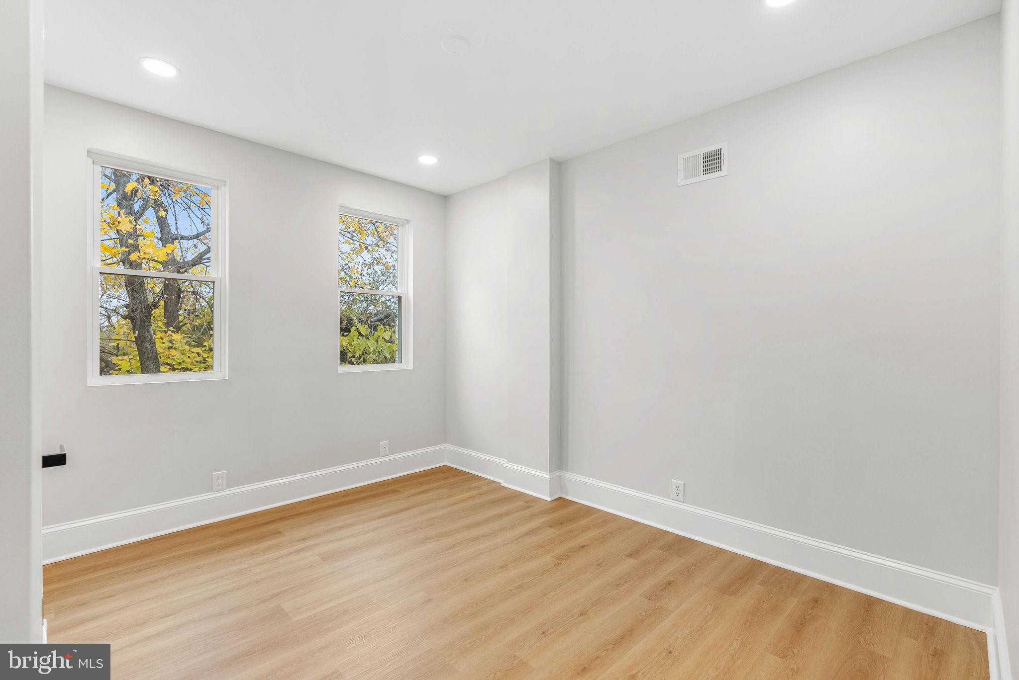 5737 Springfield Avenue Philadelphia, PA 19143 - Photo 30 of 31 wooden floor in an empty room with a window