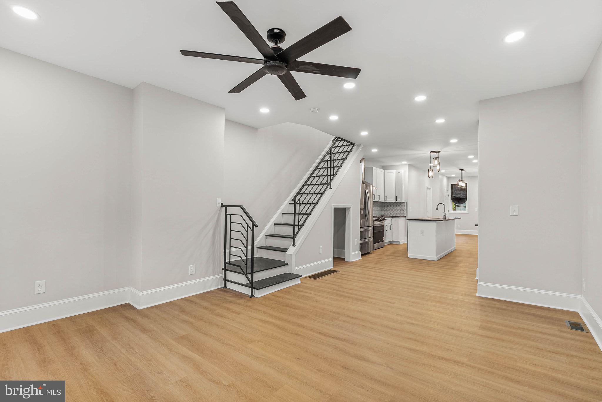 5737 Springfield Avenue Philadelphia, PA 19143 - Photo 4 of 31 a view of an empty room with wooden floor and a ceiling fan