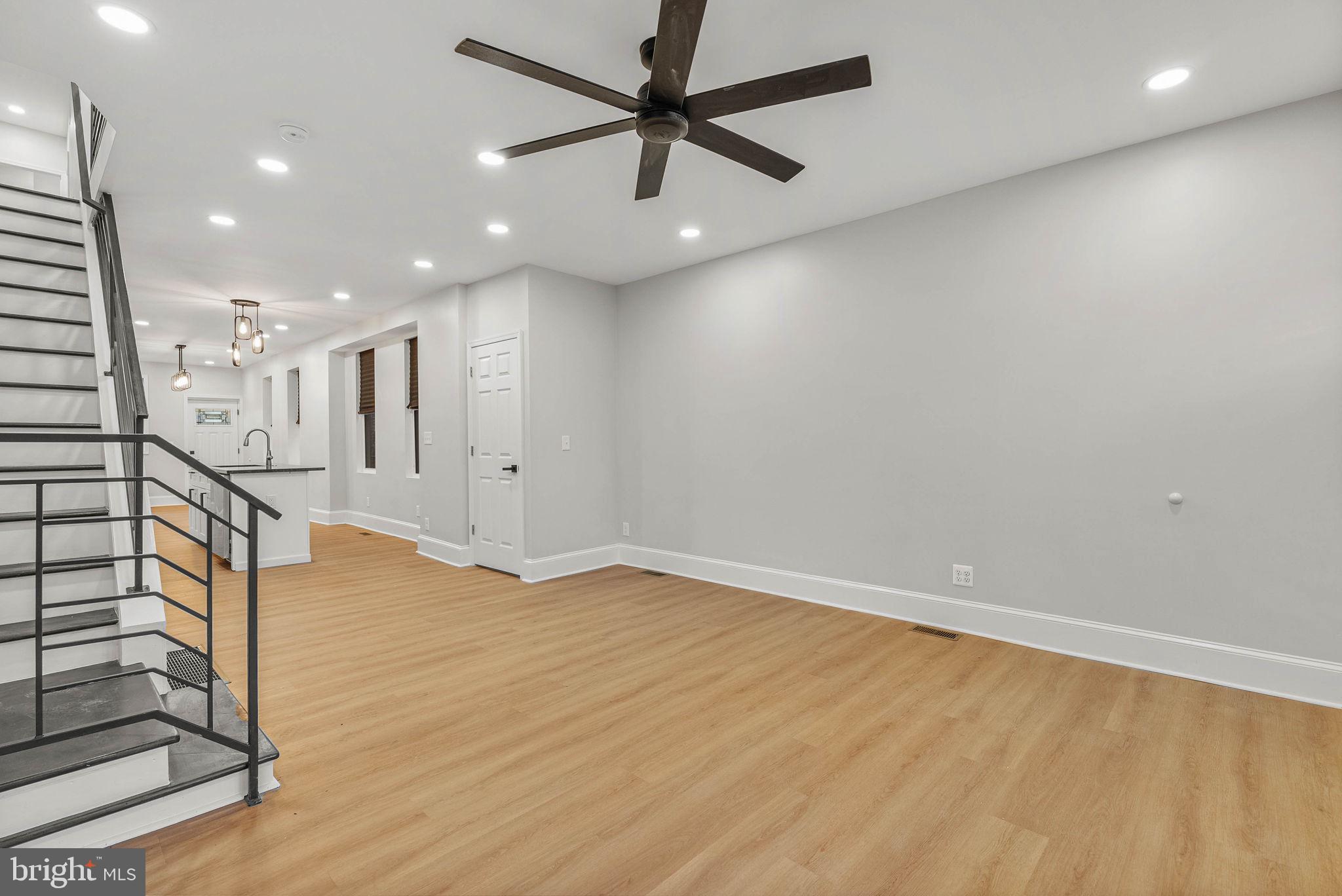 5737 Springfield Avenue Philadelphia, PA 19143 - Photo 6 of 31 an empty room with wooden floor and windows
