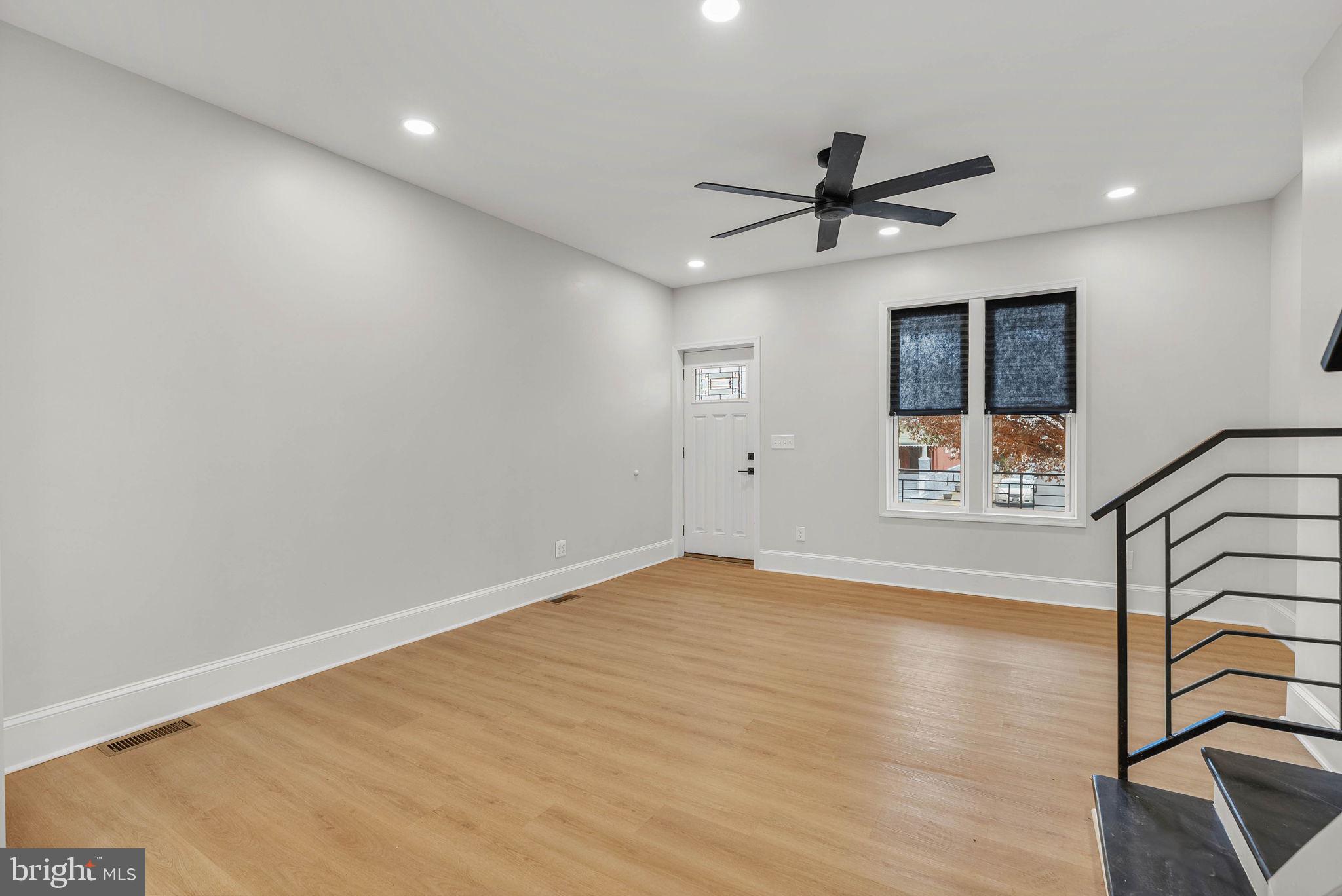 5737 Springfield Avenue Philadelphia, PA 19143 - Photo 7 of 31 wooden floor in an empty room with a window