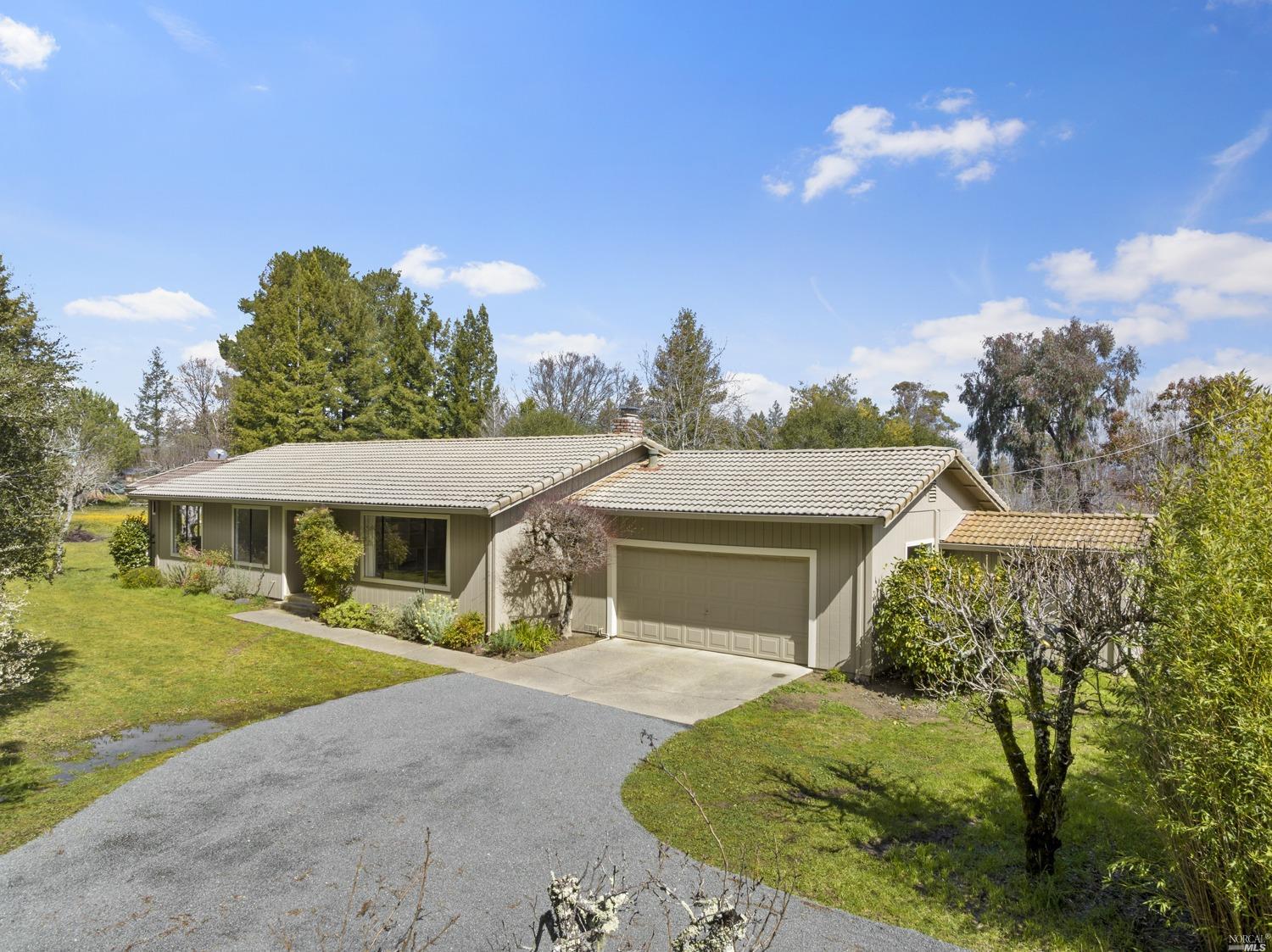13228 Dupont Road Sebastopol, CA 95472 - Photo 1 of 1 a front view of a house with a yard and garage