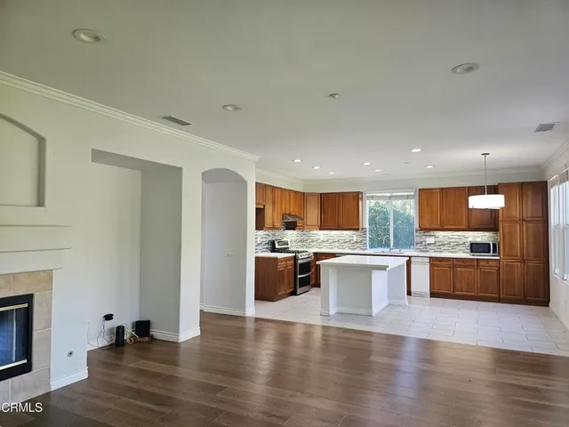 a kitchen with a counter top space a sink appliances and cabinets