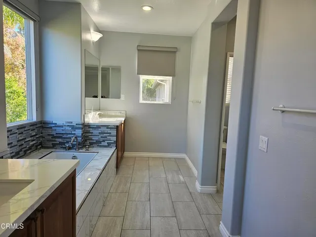 a kitchen with granite countertop a sink stove and cabinets