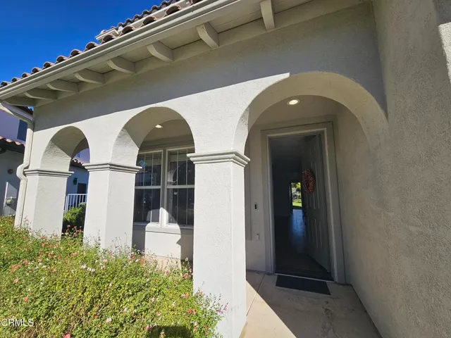 a front view of a house with plants