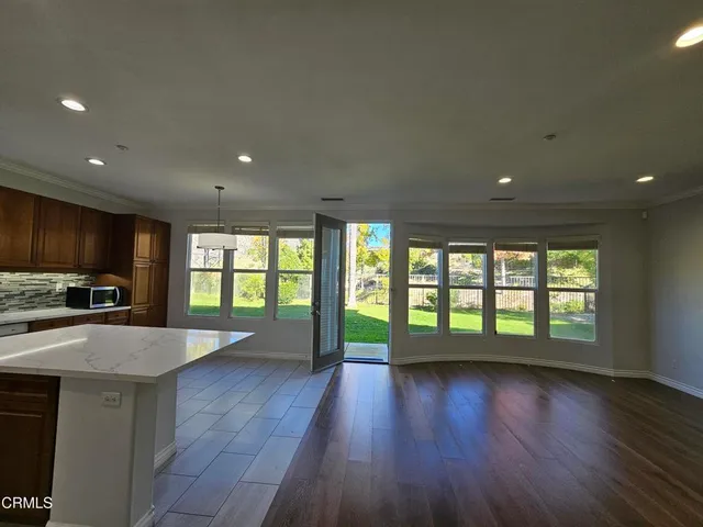 an open kitchen with a sink and a large window