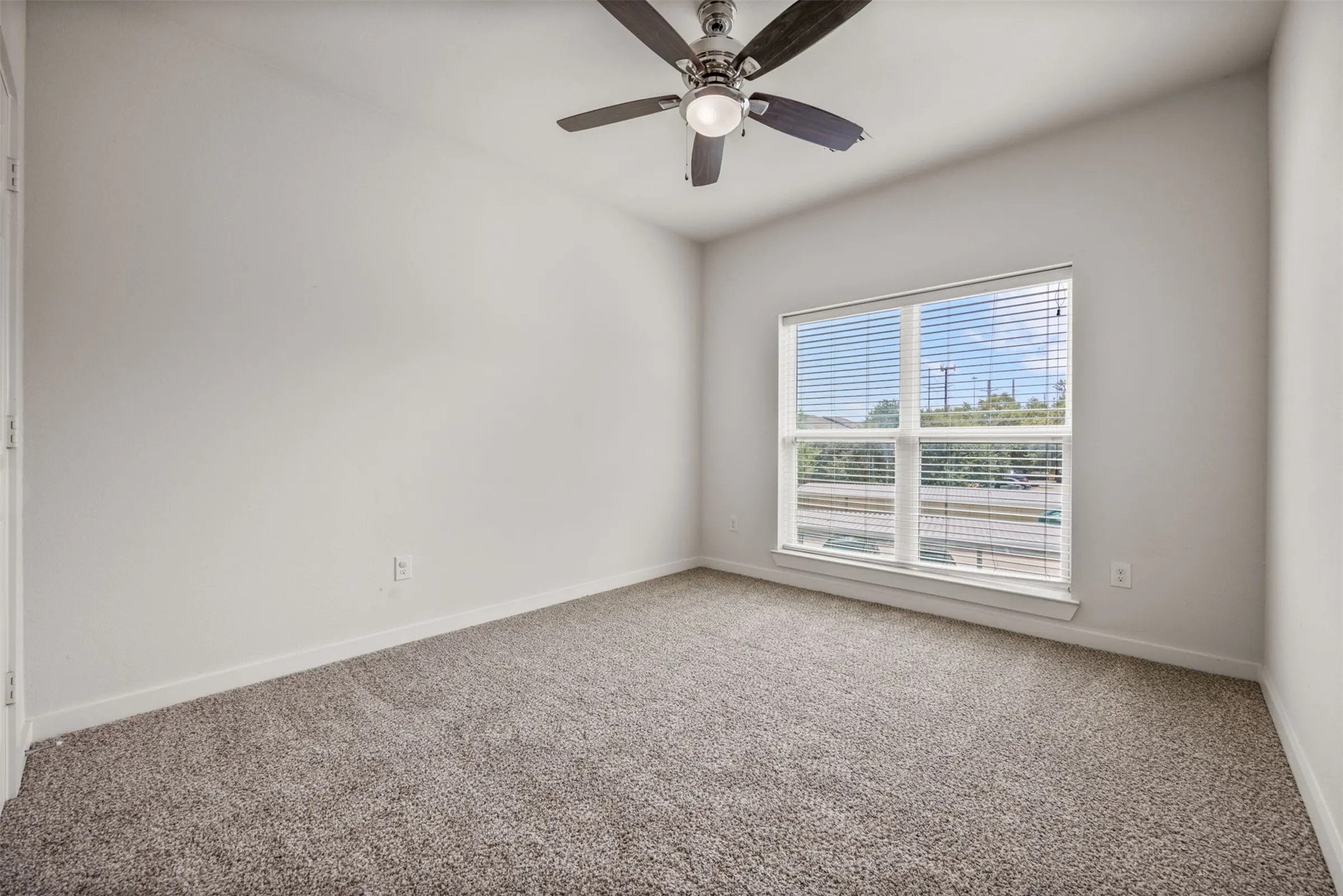 6725 Circle S Road, Unit B1257 Austin, TX 78745 - Photo 7 of 23 an empty room with windows and fan