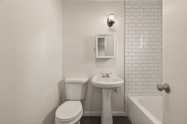 a bathroom with a sink a mirror and a bathtub