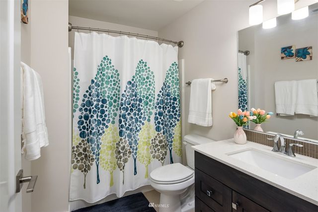 a view of a livingroom with workspace and a window