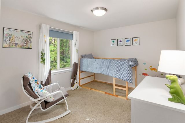 a view of a bedroom with furniture and a window
