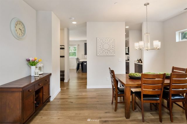 a dining room with furniture and wooden floor