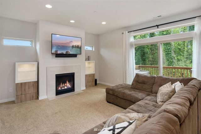a large bed sitting in a bedroom next to a window