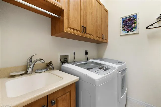 a view of patio with chairs and table under an umbrella