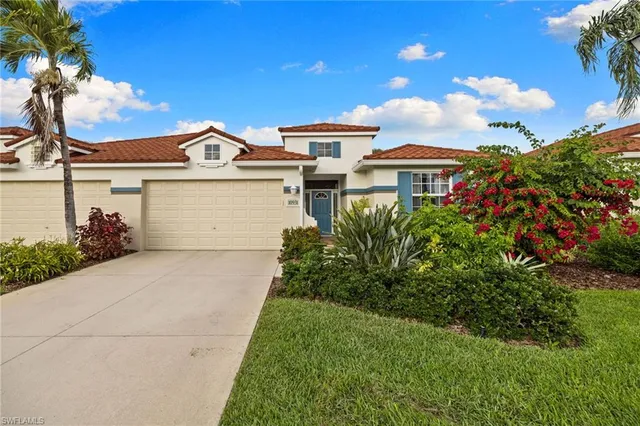 an aerial view of a house with garden space and ocean view